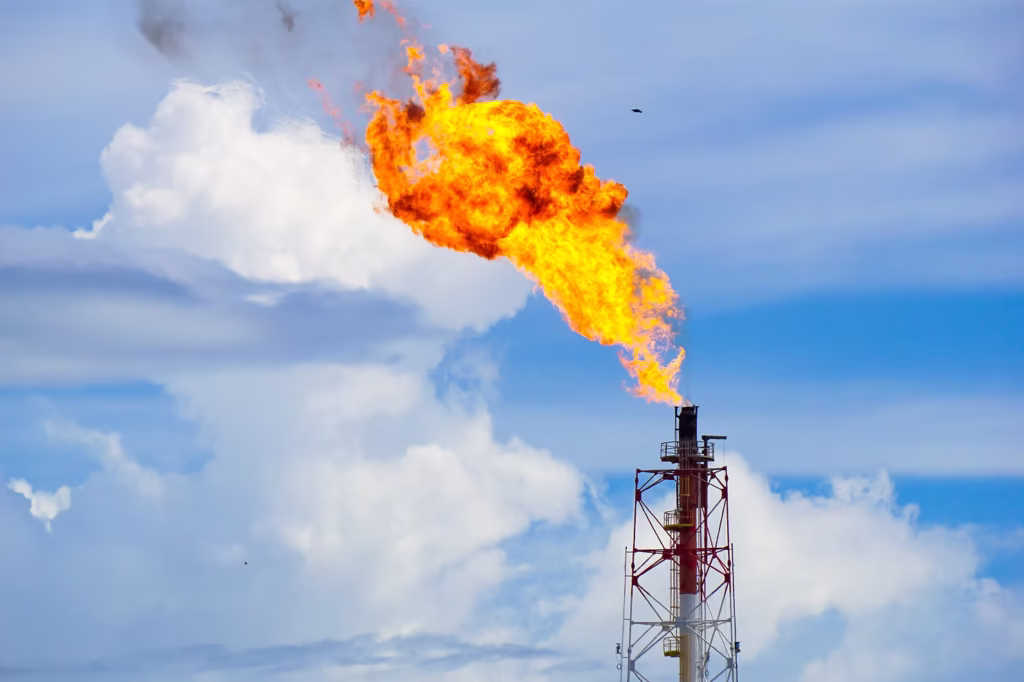 Flame burning from industrial smokestack