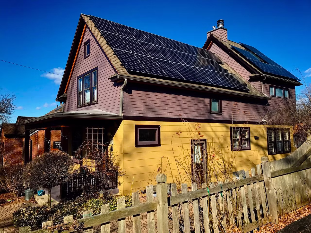 House with solar panels and fence