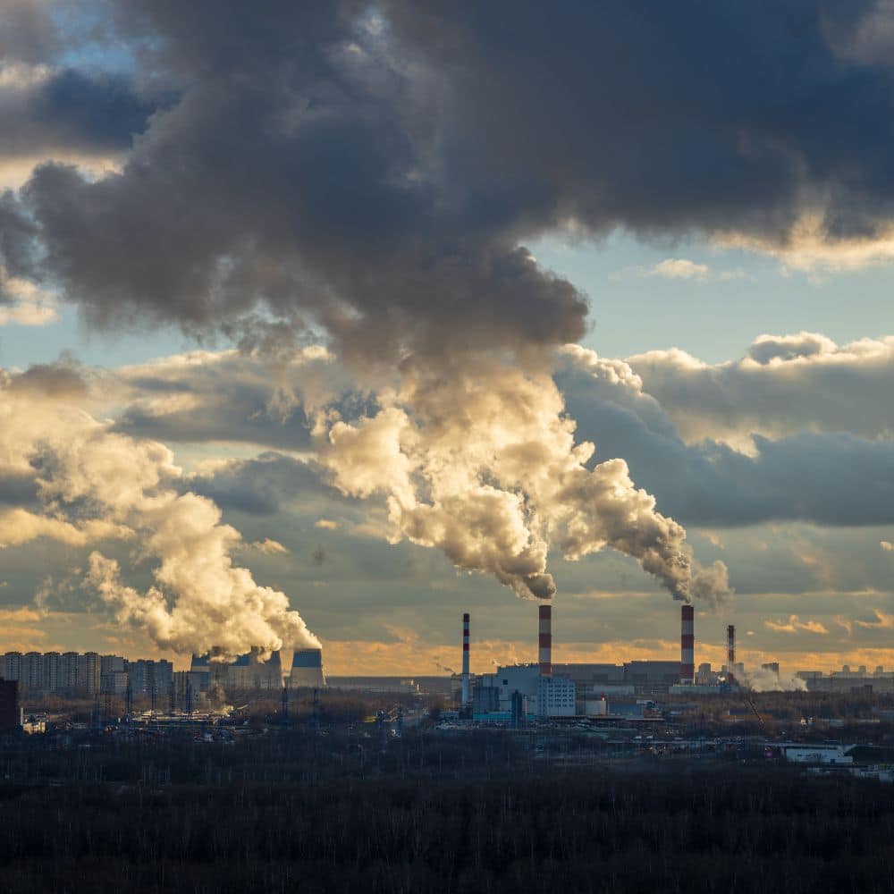Industrial smoke against cloudy sky