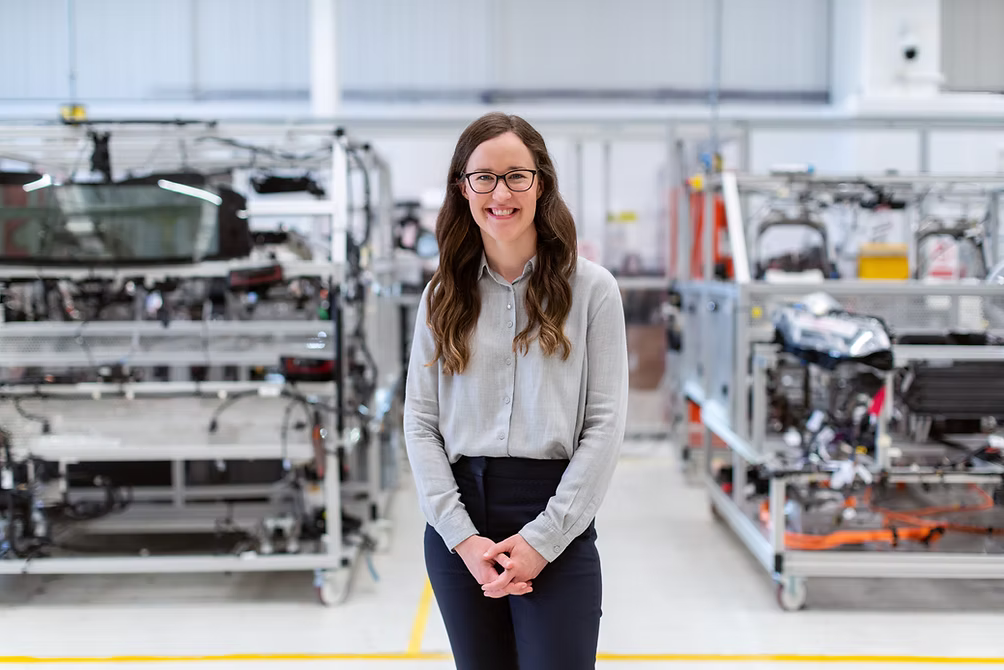 Person standing in industrial workspace.